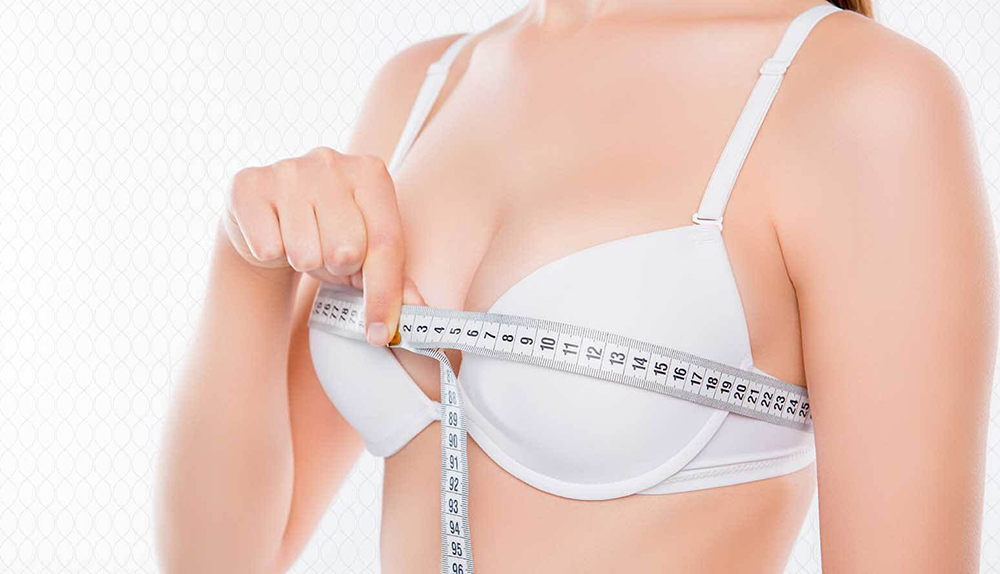 Woman measuring bust with tape.